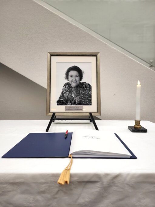 Porträtt. ljus och kondoleansbok på bord